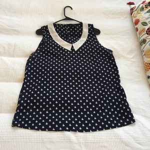 Blue sleeveless sailboat print blouse.
